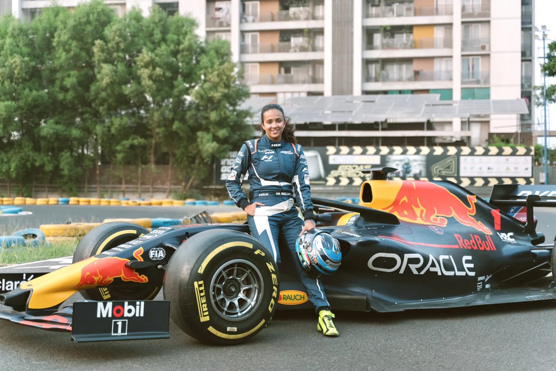 Mira Erda standing beside an Oracle Red Bull Racing Formula 1 show car